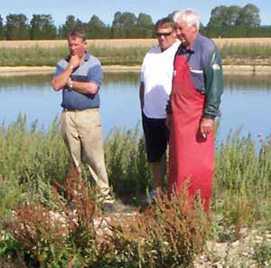 Gerard centre watches the pondbuster in action with clients.